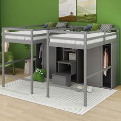 a loft bed with a desk underneath it in a room that has green walls and hardwood floors