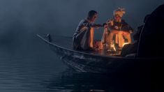 two people sitting in a boat on the water, one holding a lit lantern and another standing next to him