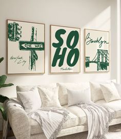 three green and white prints hang on the wall above a couch in a living room