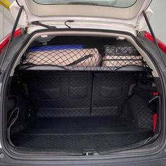 the back end of a small car with luggage in it's trunk and cargo compartment