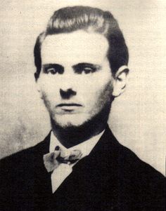 an old black and white photo of a man with a bow tie