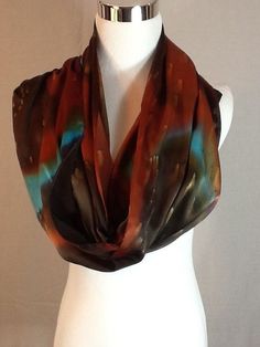 Elegant  Charmeuse Silk scarf in  Dark brown, burnt orange and turquoise. 14"x72"Product information:Designer - Mary Jane DavidsonMaterial- 100 % natural 19.5mm Charmeuse silkColor - any color choiceSize - 14"x72" slight shrinkage may occur from steamingPackage - Envelope or gift packageThis is the Porsche of silks! A muted crepe on the back side and shimmery lustrous satin on the top side. It is heavier and more substantial than plain Satin or Crepe de Chine, has a firm, soft, supple hand and a Burnt Orange And Turquoise, Silk Scarf Painting, Hand Painted Silk Scarf, Silk Art, Painted Silk, Mild Shampoo, Orange And Turquoise, Hand Painted Silk, Silk Wool