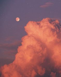 the moon is shining in the sky above some fluffy clouds and pink hues on a purple night