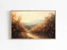 a painting hanging on the wall in front of a white wall with an orange grove