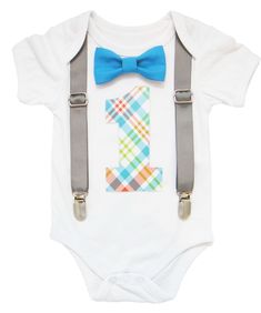 This set comes with the following Interchangeable Accessories: 1. Grey Adjustable Suspenders that Clip Onto Pants (Suspenders must be used with our bodysuit)2. Bright Blue Bow Tie3. Custom Build a Bodysuit™ 4. Plaid Print Removable Number One (removable number allows you to use your bodysuit again after your party so you get your money's worth!) NUMBER IS AN ADHESIVE VINYL STICKER. IT IS REMOVABLE SO YOU MAY USE YOUR BODYSUIT WITH OR WITHOUT THE NUMBER. We include two numbers for your convenience. It is extremely durable and made to last through your party and/or pictures. We sell numbers individually as well in our Build A Set Section. Don't get stuck with an outfit that you can only use once. With NOAH'S BOYTIQUE™ Build a Bodysuit you can use your outfit after your party or event too sin First Birthday Outfit Boy, 1st Birthday Onesie, Grey Suspenders, Boys Birthday Outfits, Birthday Clothes, Birthday Bodysuit, Birthday Onesie, Red Birthday, First Birthday Outfit