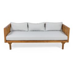 a wooden couch with four pillows on it's back and two white cushions in the middle