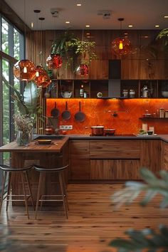 a kitchen with wooden floors and lots of plants on the counter top, along with hanging lights