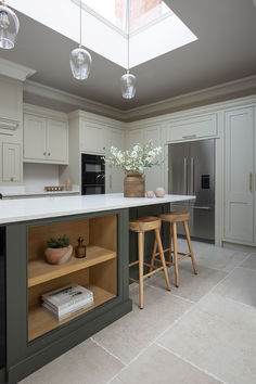 Chastleton Ivory porcelain tiles in a cream and green kitchen.