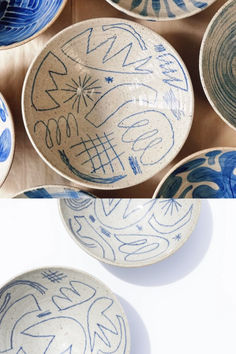 several bowls with blue designs on them are shown in three different positions, one is empty