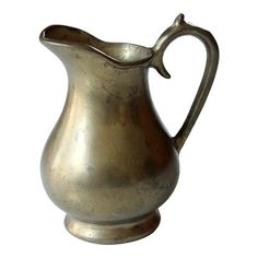 an old silver pitcher on a white background