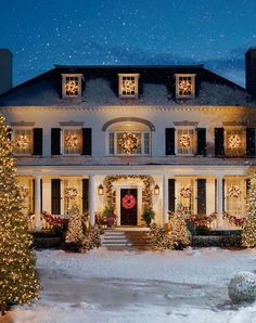 a large white house with christmas decorations on the front