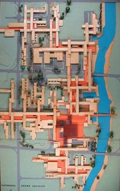 a model of a city with lots of buildings and roads on it's sides