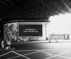 an empty parking garage with graffiti on the wall