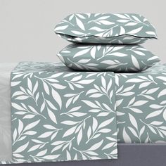 three sheets with leaves on them are stacked next to each other