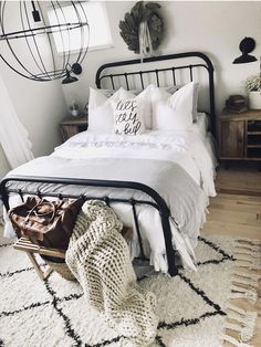 a bed with white sheets and pillows in a bedroom