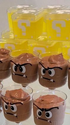 several glasses with chocolate pudding in the shape of angry birds on them and eyes drawn on them