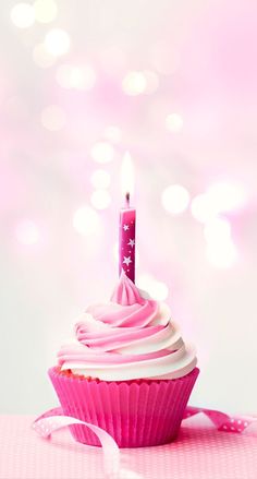 a pink cupcake with a single candle on it