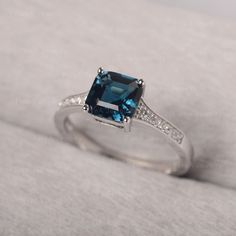 ◆ Hand-finished in Sterling sliver, this piece features a Asscher shaped London blue topaz stone. Clear zirconia stones decorate half of the ring shank. A piece of classic, it is suitable for engagement, party, daily occasion. ◆ Production Description: Main stone Type: London Blue Topaz Main Stone Shape: Asscher Main Stone Size: 7*7mm Side stone: CZ Metal: 925 Sterling silver - Other options available in the drop down menu ◆ Customization: √Free for Add Engraving √Other Metal Type Available √Oth Blue Topaz Princess Cut Ring In Sterling Silver, Sterling Silver Asscher Cut Topaz Ring, Sterling Silver Asscher Cut Topaz Ring For Anniversary, Sterling Silver Topaz Ring Asscher Cut, Asscher Cut Topaz Ring In Sterling Silver For Anniversary, Green Sapphire Ring, Minimalist Engagement Ring, Ring Shank, White Topaz Rings