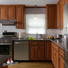 a kitchen with wooden cabinets and stainless steel appliances