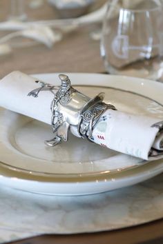 a white plate topped with a rolled up napkin