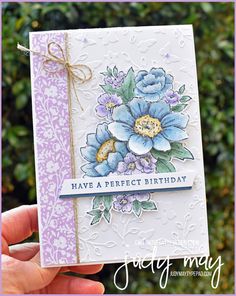 a hand holding up a card with flowers on it and the words have a perfect birthday