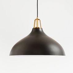 a black and gold pendant light hanging from a ceiling