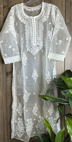 White Chikankari kurta on organza! Delicate hand embroidery and mukaish add ons on lightweight sheer fabric. Includes a liner slip. Length- 47 inches White Salwar Kameez With Intricate Embroidery For Diwali, White Salwar Kameez For Eid Celebration, White Bollywood Salwar Kameez For Celebration, Festive Organza Kurta With Lace Work, White Anarkali Kurta In Organza, White Organza Salwar Kameez With Intricate Embroidery, White Resham Embroidery Salwar Kameez For Celebrations, White Salwar Kameez With Resham Embroidery For Celebration, Festive Lace Work Organza Kurta