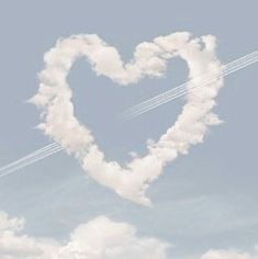 two airplanes flying in the shape of a heart