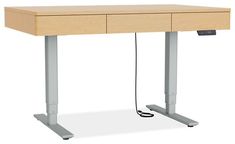 a wooden desk with two metal legs and an electric cord plugged into the top