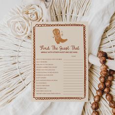 a brown and white brochure sitting on top of a table next to some tassels