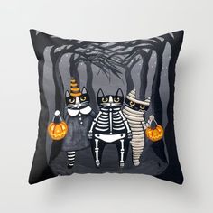 three cats in halloween costumes are holding pumpkins