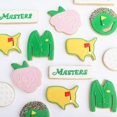 decorated cookies are arranged in the shape of men's golf attire and hats, with words on them