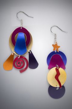 Aluminum Earrings - Designed, anodized, dyed, hand fabricated by the artist, these asymmetric earrings are a blast of autumn colors in purple, gold, plum, orange, magenta, & deep red. With details like a thunder bolt, rain drops, a swirl, a star, these earrings grab your attention as they move playfully on the ear. Surgical steel ear wires. Asymmetric Earrings, Thunder Bolt, Shrink Plastic Jewelry, Aluminum Earrings, Shrink Art, Art Earrings, Plastic Jewelry, Autumn Colors, Acrylic Earrings