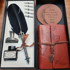 an open box containing a note book, pen and feather quill