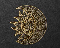 a black and gold cover with an intricate design on the front, featuring a stylized sun