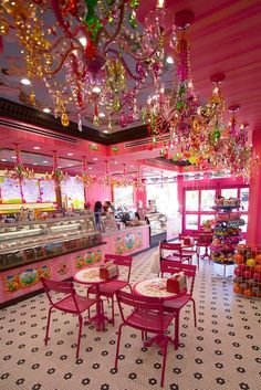 the inside of a candy shop with tables and chairs