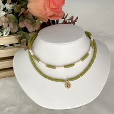 Heishi necklace, olive green necklace, Heishi boho necklace, dainty flower necklace, simple beaded necklace, summer bead necklace. These boho chic chokers are very trendy and they match with your daily outfit. If you are looking for stylish summer necklace to enhance your daily outfit, you found them! They're easy to wear everyday alone or layered with other favorite necklaces. 💕 ITEM DETAILS: Length: 14 - 16 inches. The length of the necklace refers to the total length from end-to-end. Materia Bohemian Summer Necklace With Flower Pendant, Bohemian Flower Pendant Necklace For Summer, Adjustable Green Flower Beaded Necklaces, Green Adjustable Flower Beaded Necklaces, Green Adjustable Necklace With Flower Charm, Dainty Green Adjustable Beaded Necklaces, Dainty Handmade Green Beaded Necklace, Adjustable Green Flower Necklace With Round Beads, Bohemian Flower Necklace With Tiny Beads