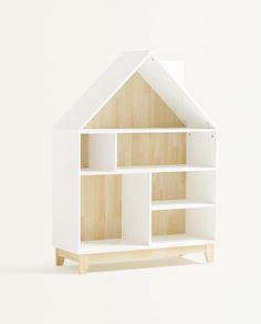 a doll house made out of wood and white paint