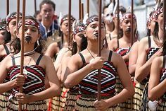 a group of women in native garb standing next to each other with their hands on their hipss