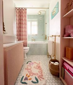 a bathroom with pink and white decor in the bathtub, shower curtain, rug on the floor