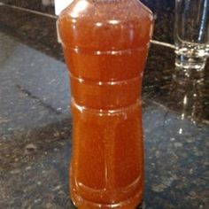 an orange vase sitting on top of a counter