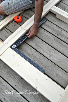 a man is working on some wooden boards