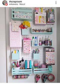 a peg board with craft supplies on it and scissors hanging from the wall behind it