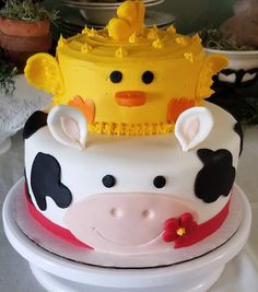 a cake decorated with a cow wearing a crown