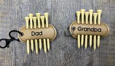 two wooden combs with the words dad and grandpa written on them