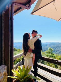 a man and woman embracing on a deck