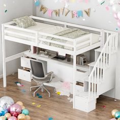 a white loft bed sitting under a desk next to a stair case filled with confetti