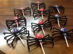 six lollipops wrapped in black string on a table