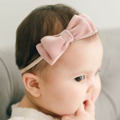 Handmade in the USA Sweet and chic, made with a super soft velvet ribbon, our tiered double loop velvet bow headband is the perfect finishing touch to her special outfit! A hand-stretched nylon band allows for a comfortable fit that will grow with your little one. Double face velvet ribbon Hand-stretched nylon Baby pictured in Large bow Cute Adjustable Hair Accessories With Satin Bow, Adjustable Pink Bow Headband, Adjustable Pink Headband With Bow, Cute Adjustable Bow With Matching Headband, Adjustable Pink Bow Tie, Cute Adjustable Headband With Bow Tie, Cute Adjustable Pink Bow Hair Accessories, Cute Adjustable Hair Accessories With Pink Bow, Pink Satin Bow Headband Gift