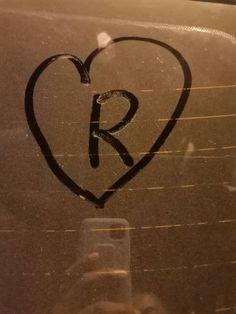 a heart drawn on the window of a car